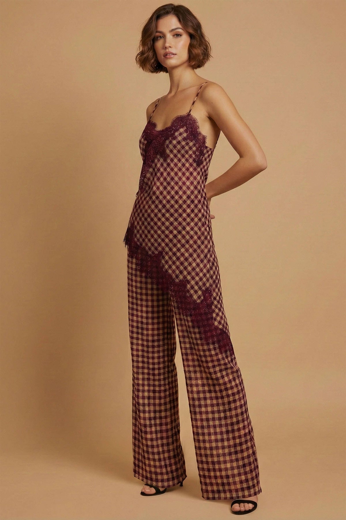 Woman wearing a checkered outfit with a sheer overlay on a beige background